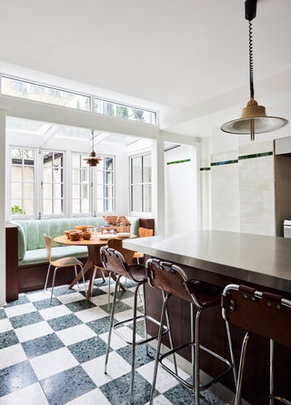 The basement kitchens main piece is a rare Poul Henningsen copper pendant from 1936 seen above the breakfast table. The...