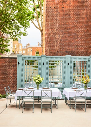 In the garden blue aluminum tables and chairs from Tectonas 1800 collection.