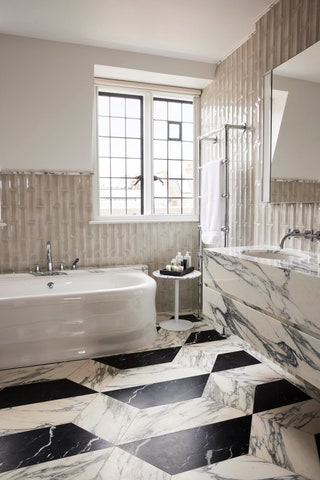 A marble clad guest bathroom.