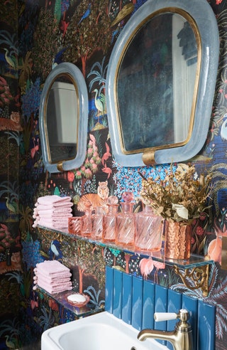 In this blue and pink powder room Carlo Scarpa mirrors are paired with Pierre Frey wallpaper.