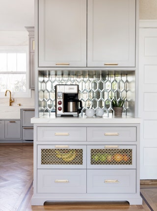 Tucked in a bright eatin kitchen this coffee bar combines moody gray cabinetry brass hardware and tarnishedmirror...