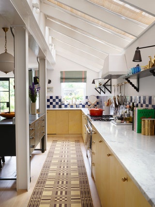 kitchen with yellow cabinets and checkerboard backsplash