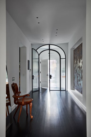 entrance hall with white walls and arched doorway