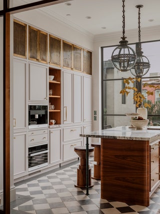 Designed by Zoe Feldman this Capitol Hill brownstone kitchen has a builtin Miele espresso machine bookended by...