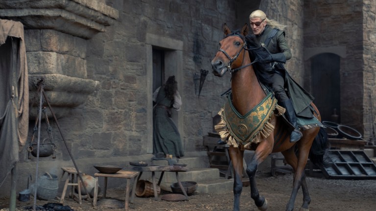 Aemond Targaryen (Ewan Mitchell) rides horseback through King's Landing
