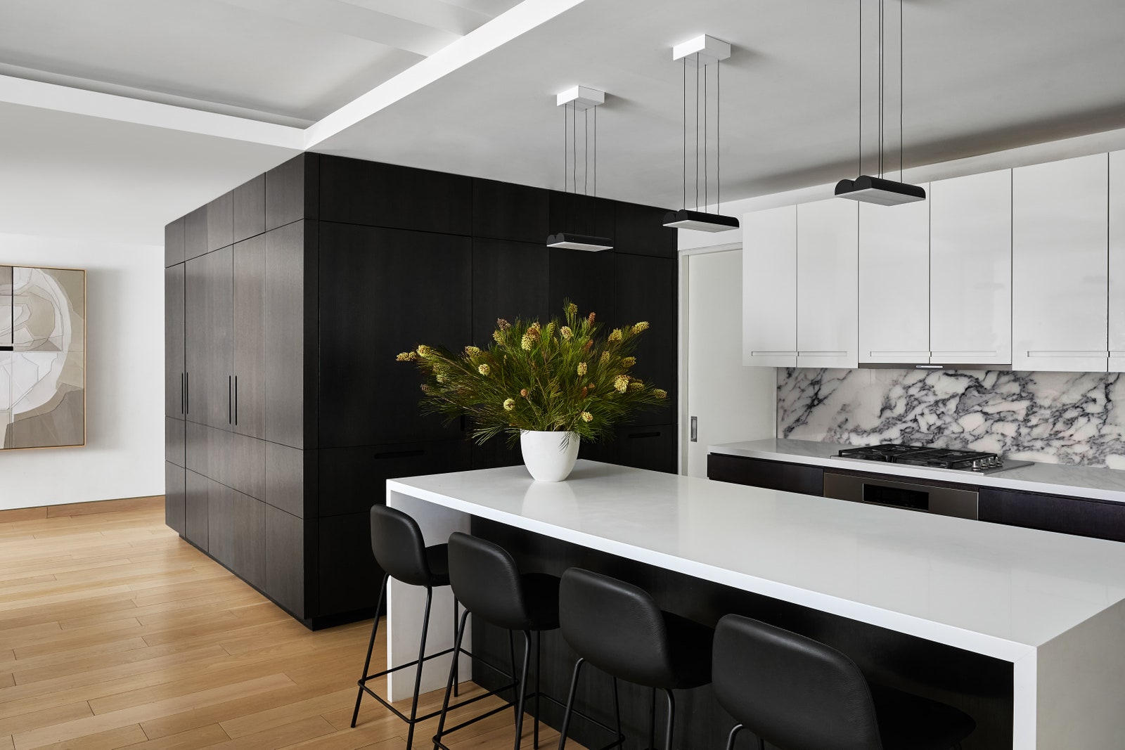 In this prewar apartment renovation interiors whiz Justin Charette opted for both black and white cabinets—and the...